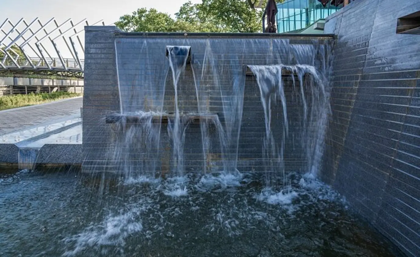 Stone waterfall wall pool water feature by Heavenly Outdoor in Fulshear, TX