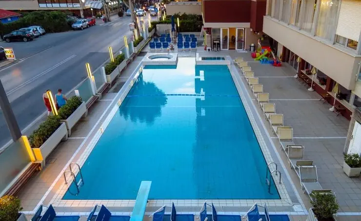 Long rectangular residential swimming pool with sun deck by Heavenly Outdoor in Galveston, TX