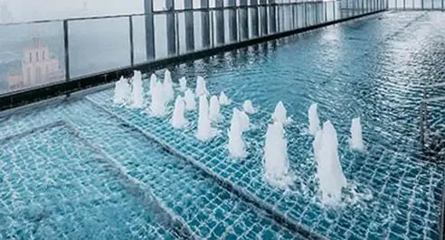 Bubblers and water bowls on a shallow pool ledge